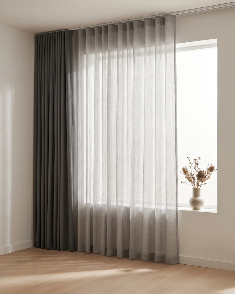 A sheer layered in front of a blockout curtain
