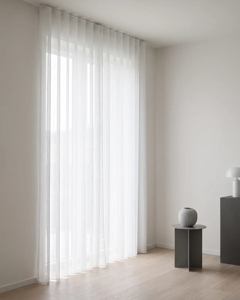 Sheer S fold curtain in an even wave across a tall window, daylight filtering through the weave