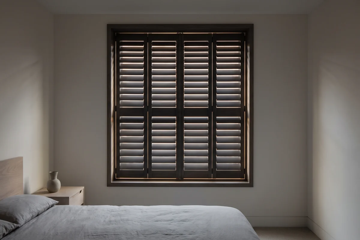 Shutter blades fully closed with a fine line of daylight showing between each one