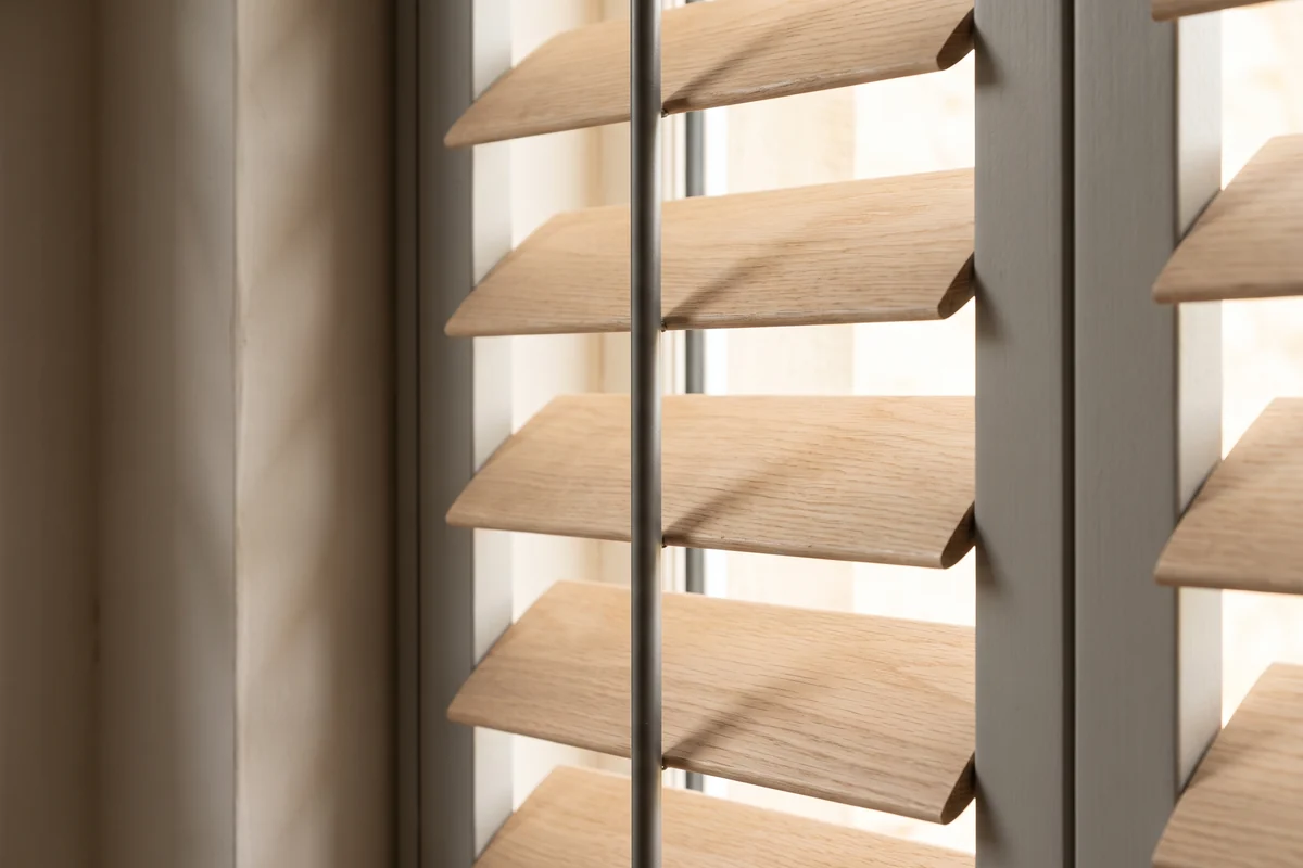 Close view of wide shutter louvre blades tilted part open
