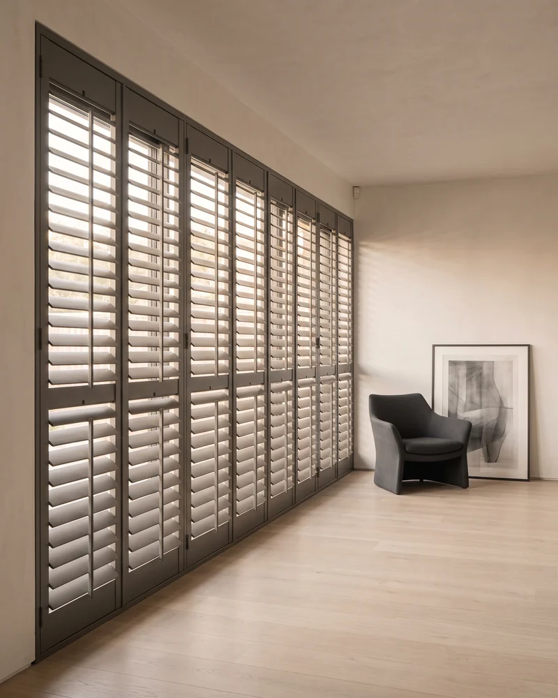 Shutter panels covering a wide span of glass