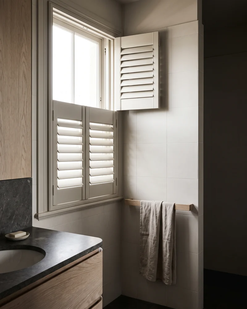 Shutters fitted to a bathroom window for privacy