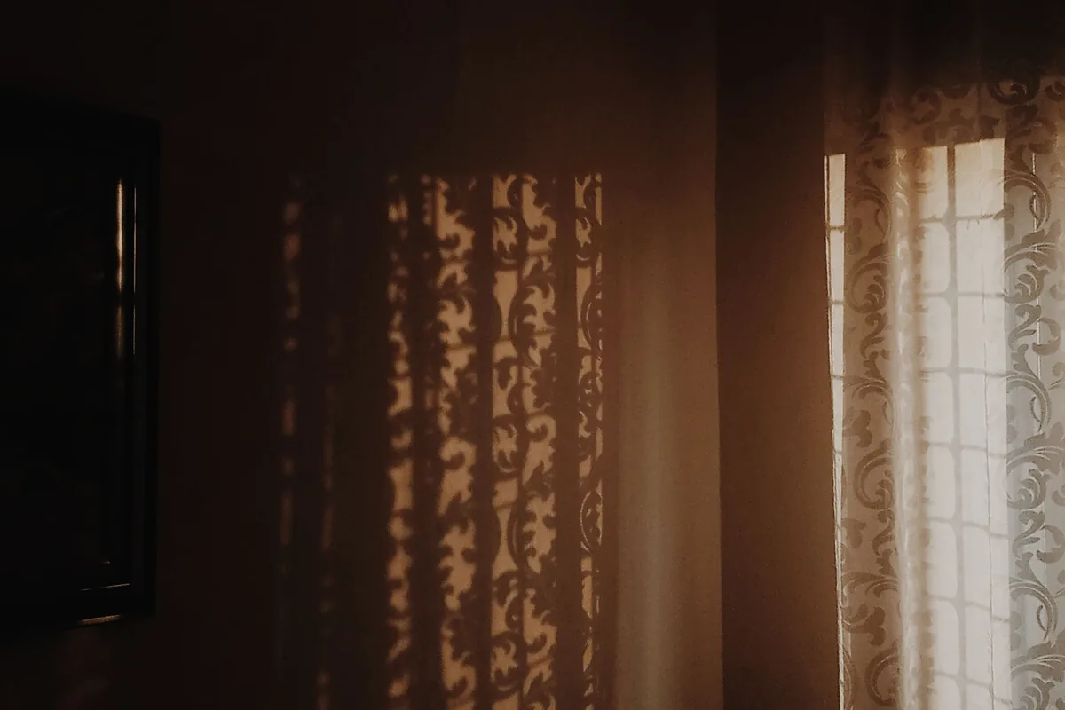 Strong late afternoon sunlight coming through a large living room window