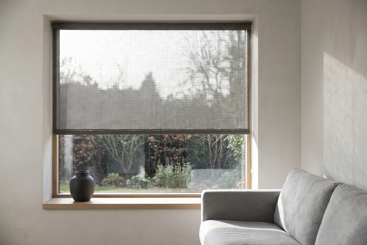 A sunscreen fabric filtering daylight with the view still visible