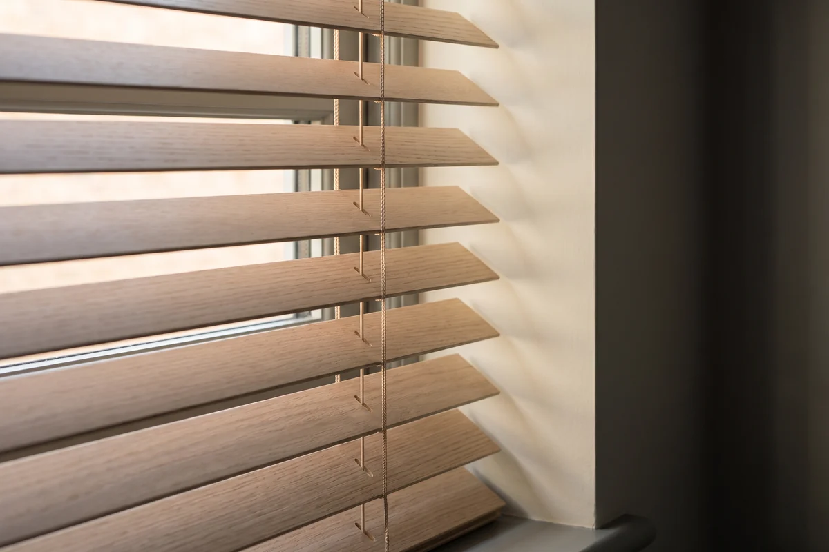 Close-up of clean timber venetian blind slats in low sunlight