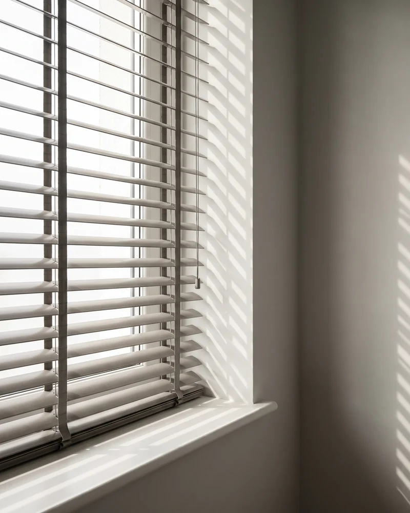 Venetian blind slats angled against daylight