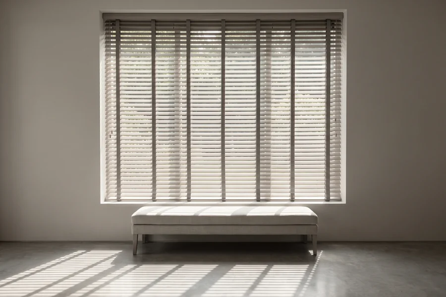 Venetian blind slats tilted part-open at a living-room window