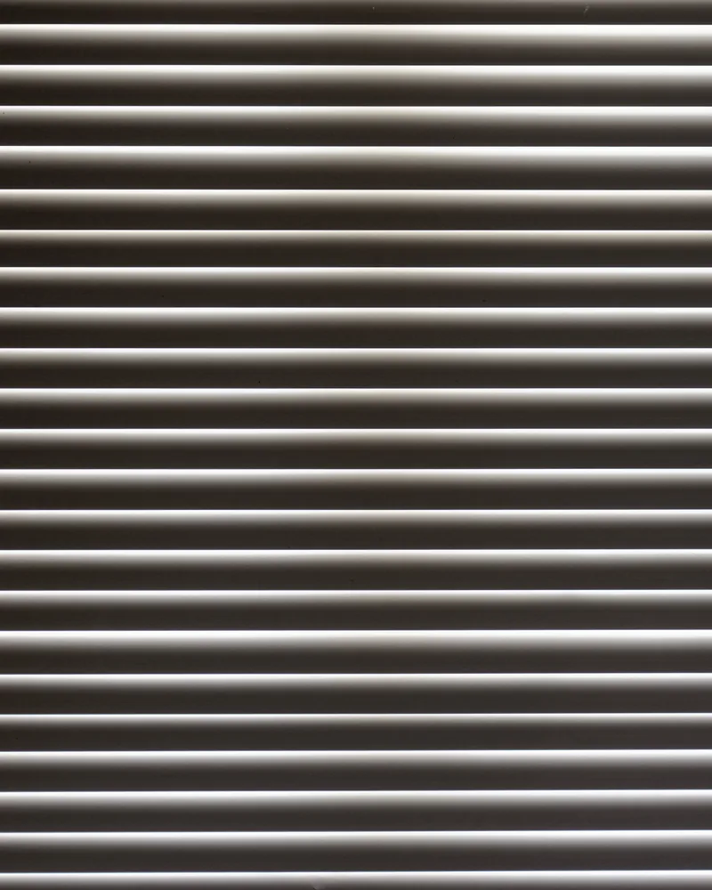 Venetian blind slats in interior daylight