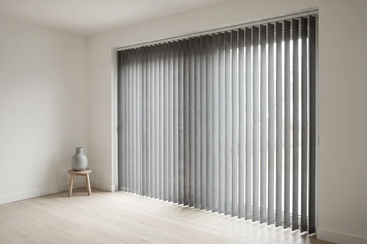 Vertical blind slats rotated part-open across a sliding door