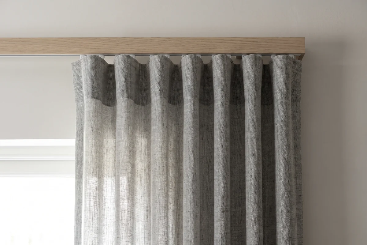 Close detail of a wave fold curtain heading showing evenly spaced soft folds