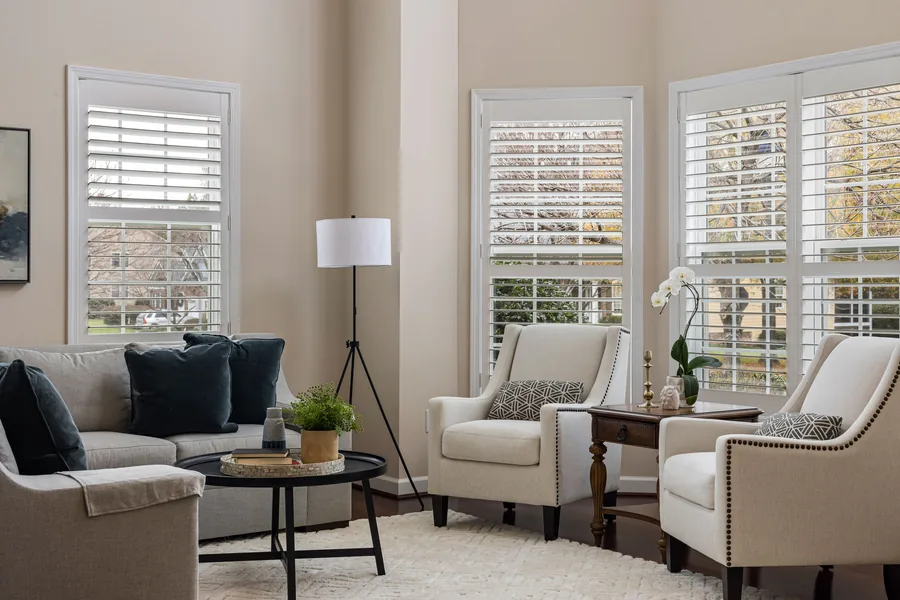White polymer shutters across the windows of a living room