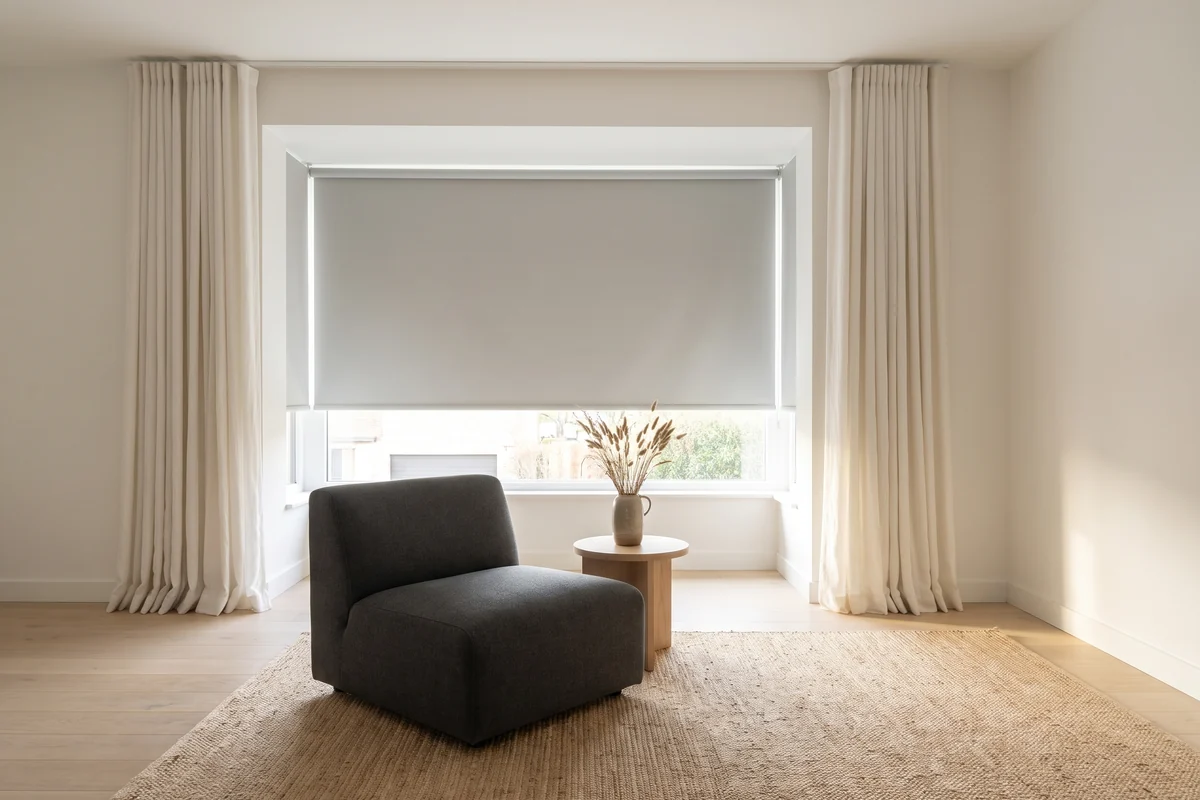 A living room with blinds and curtains working together at one opening