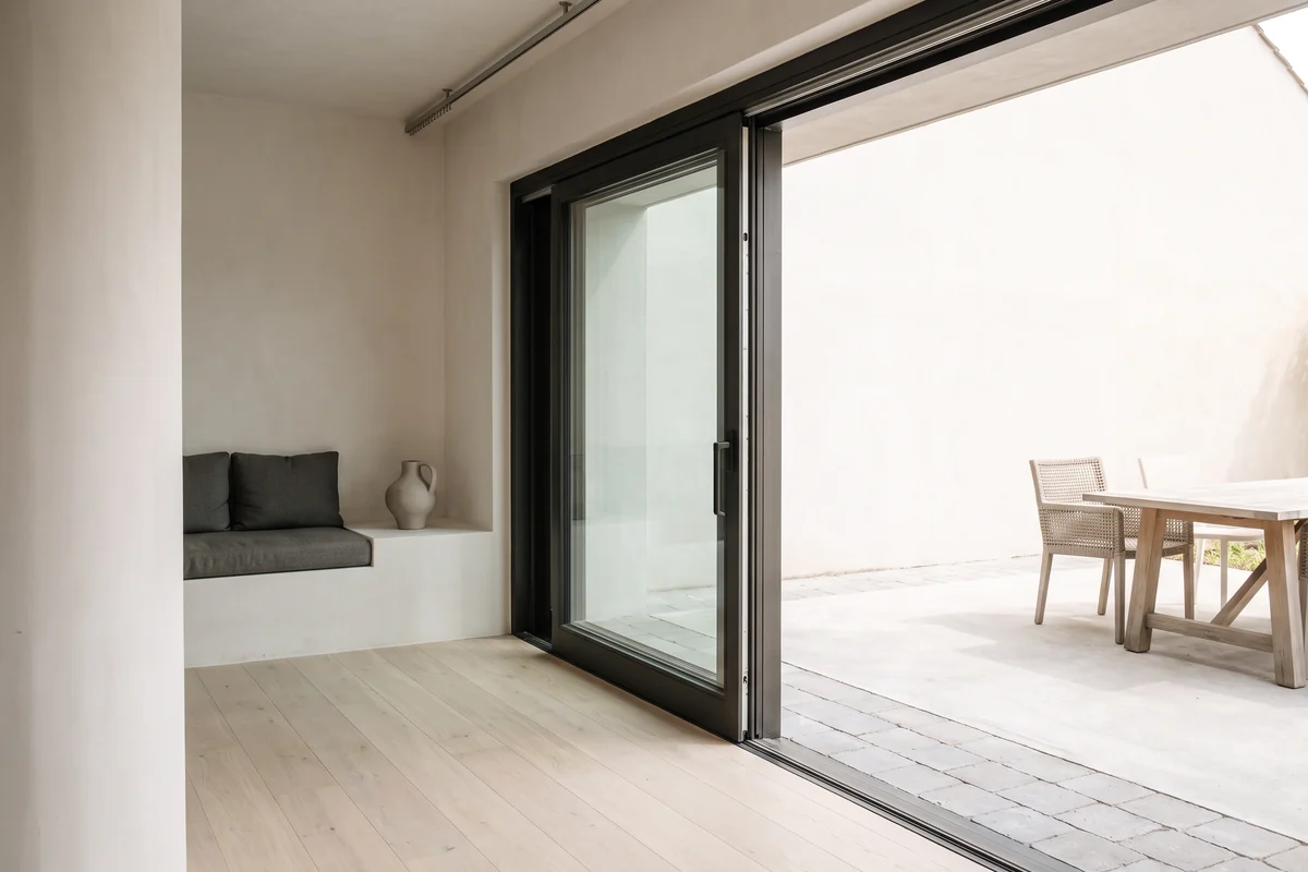 A wide sliding door open to a patio in a Queensland home