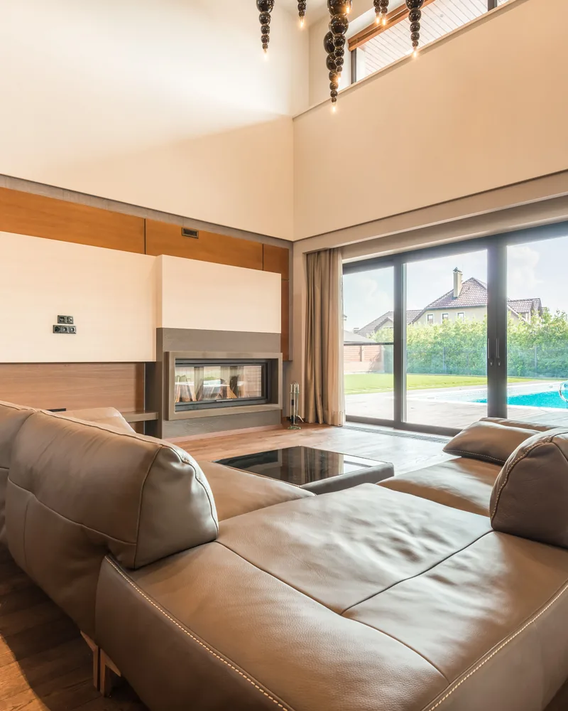 A living room with a wide sliding door onto the yard