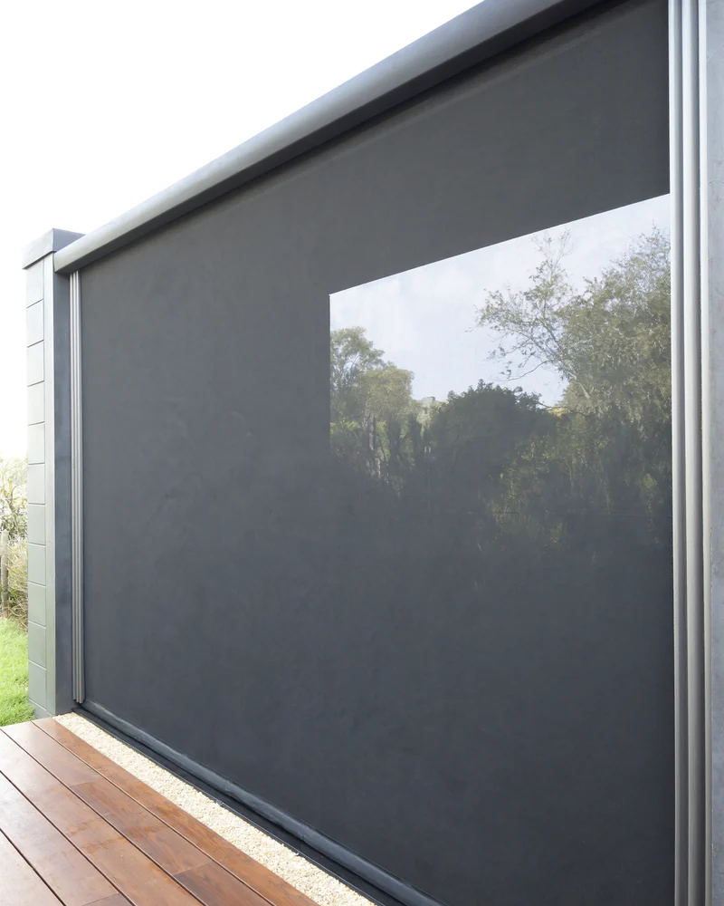 A track-guided zip blind enclosing an alfresco area